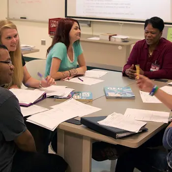 Group of people sitting around a table talking