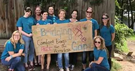 Group of OTA students with banner