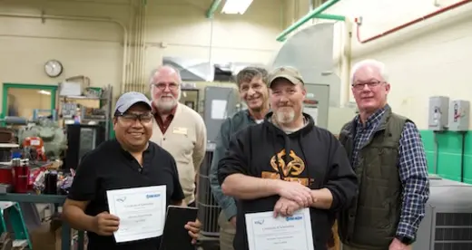 Five men in an HVAC shop