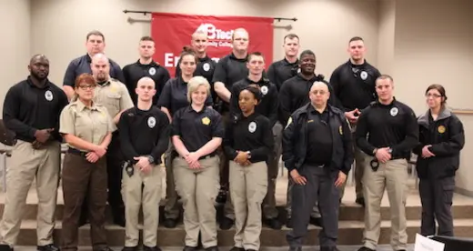 18 Detention Center officers standing in tiered group