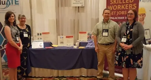 Pictured, from left, are Amanda Whitt, Pamela Silvers, Jim Sullivan and Rachael Tipton in front of a display table.