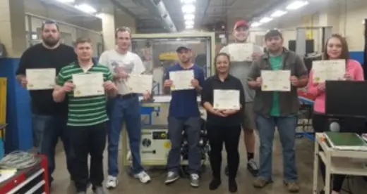 Eight students holding certificates.