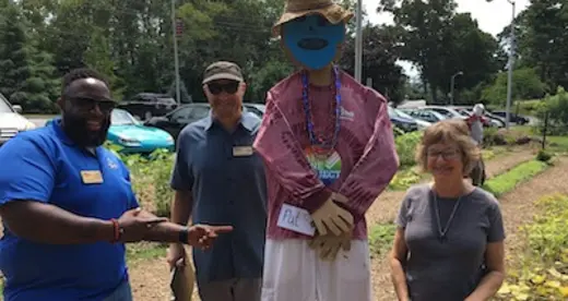 Three people and a scarecrow