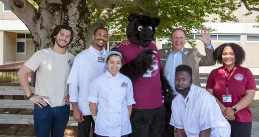 Dr. Gossett poses with a group of students