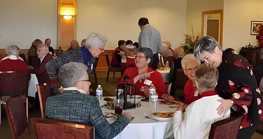 Men and women in a dining room eating brunch. 