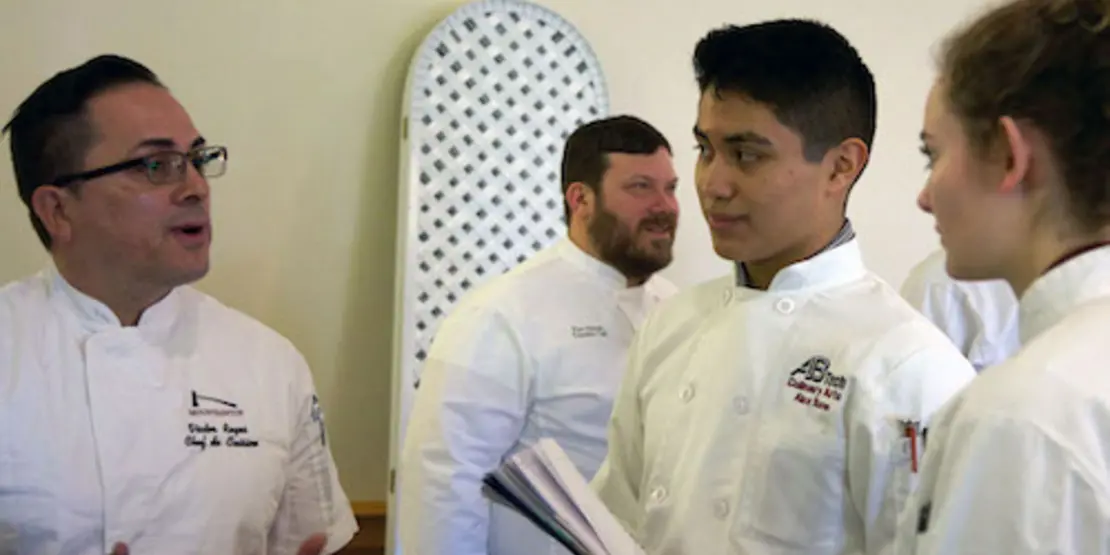 Alex Baron speaking to a chef