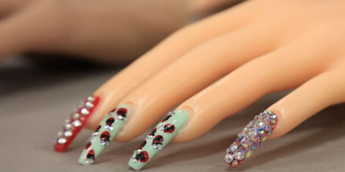 Cosmetology mannequin showing off nail manicure