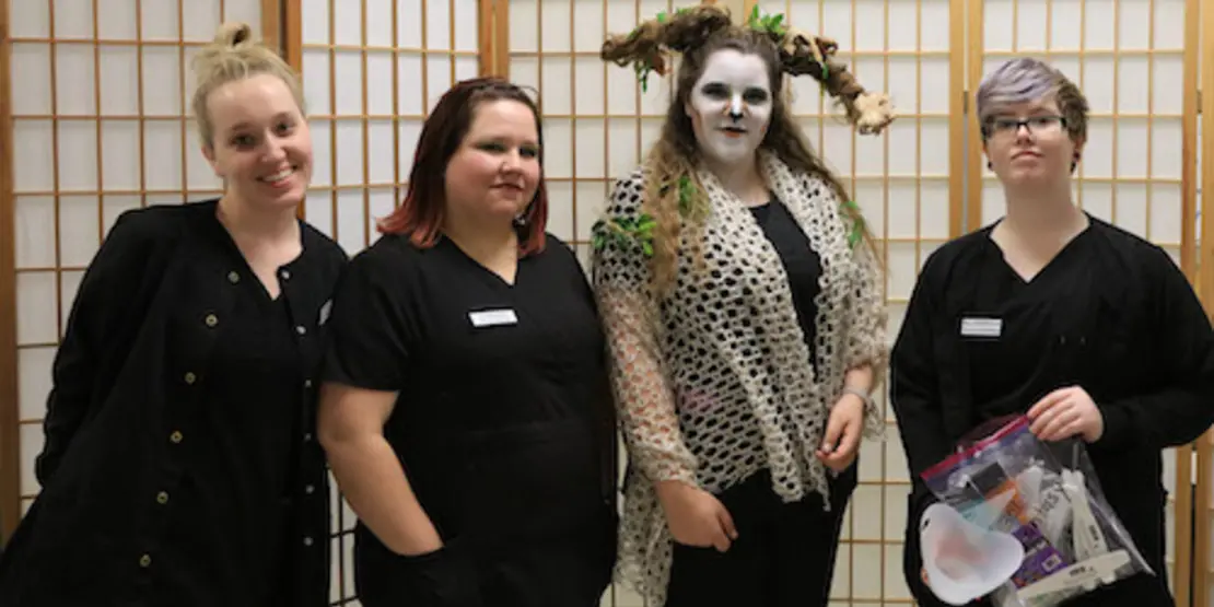 Cosmetology students with a model