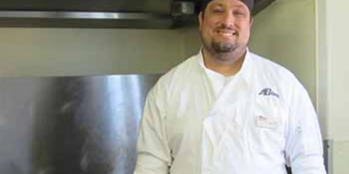 Chef Al in front of an oven