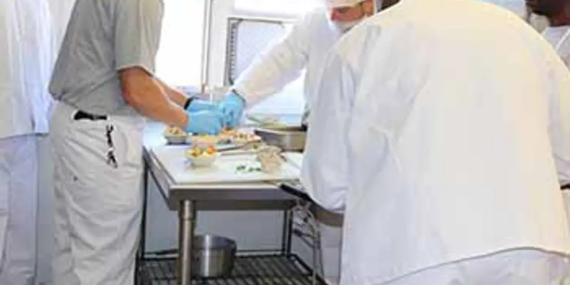 Five chefs working in the kitchen