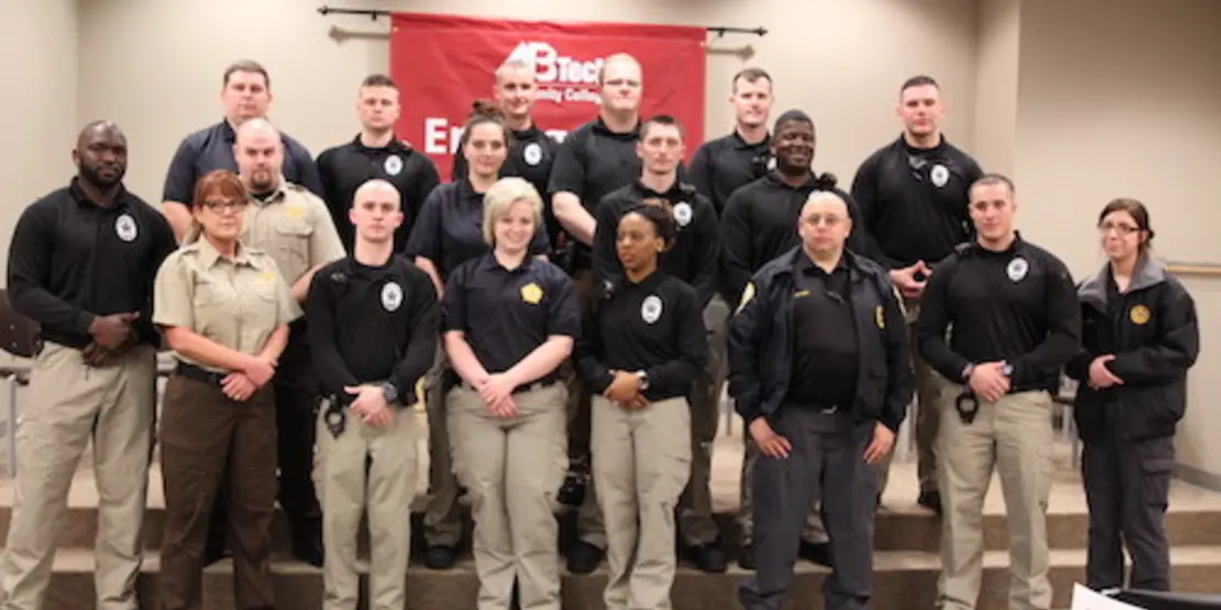 18 Detention Center officers standing in tiered group