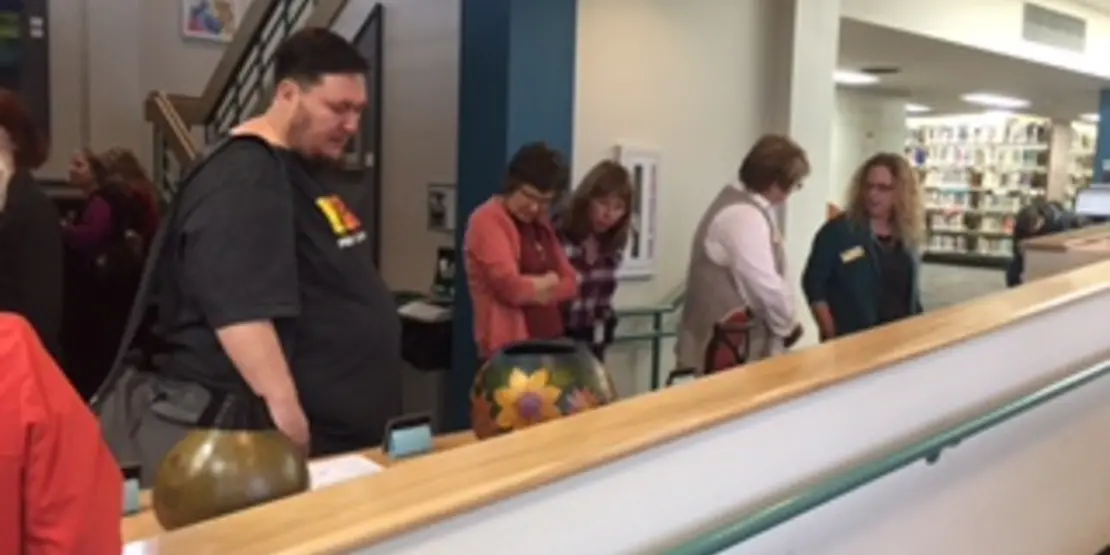 People looking at crafts on a shelf
