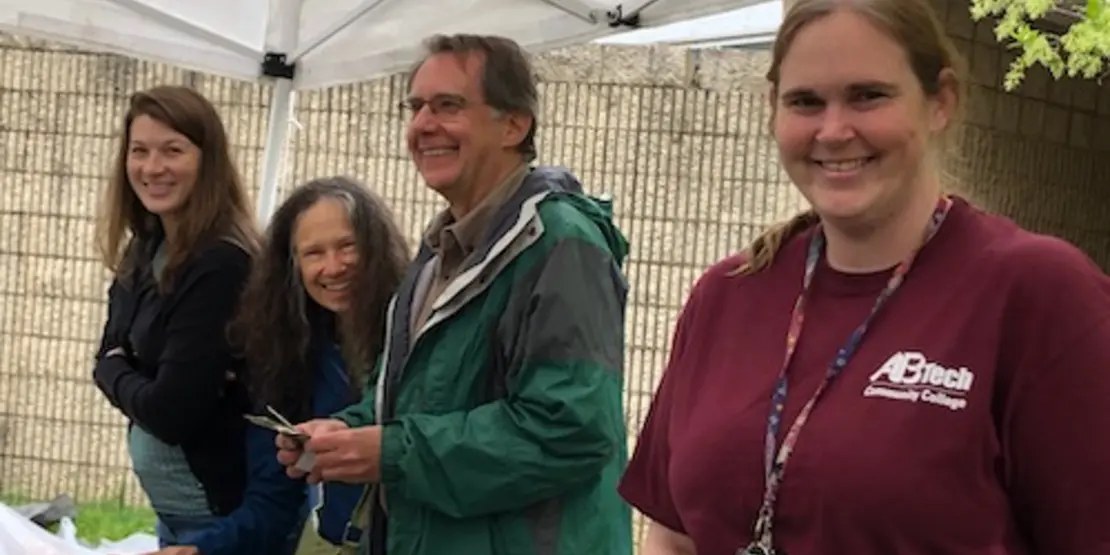 People at plant sale booth