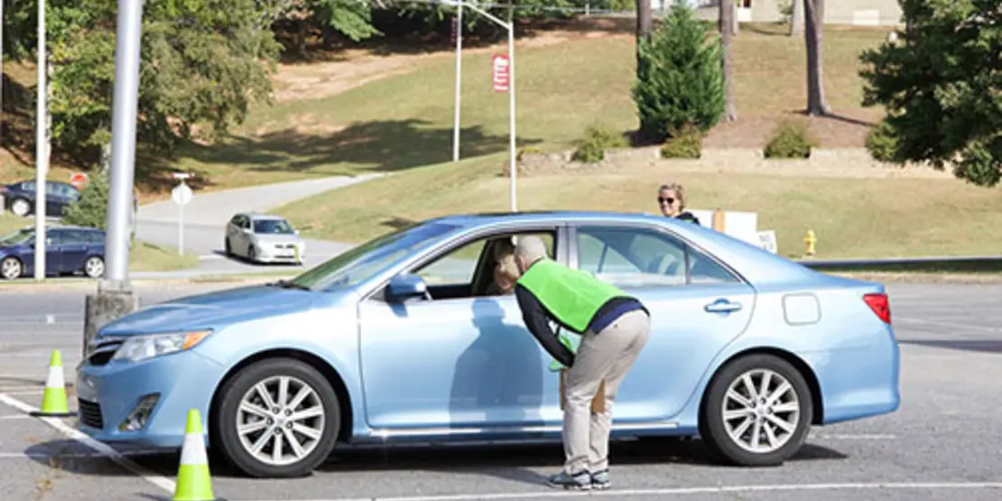 Right-side mirror check at the free CarFit Checkup event