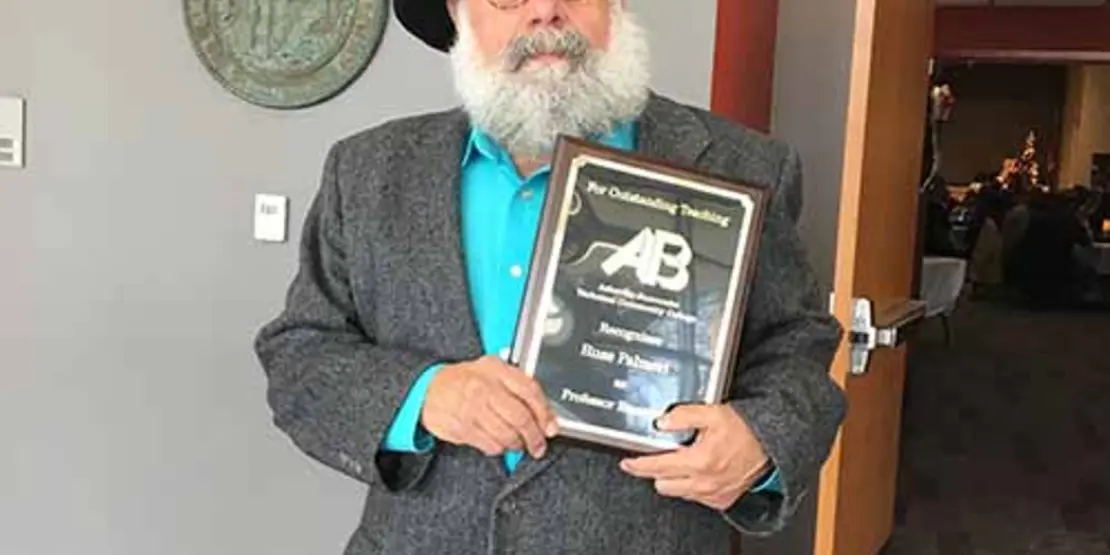 Russ Palmeri holding award