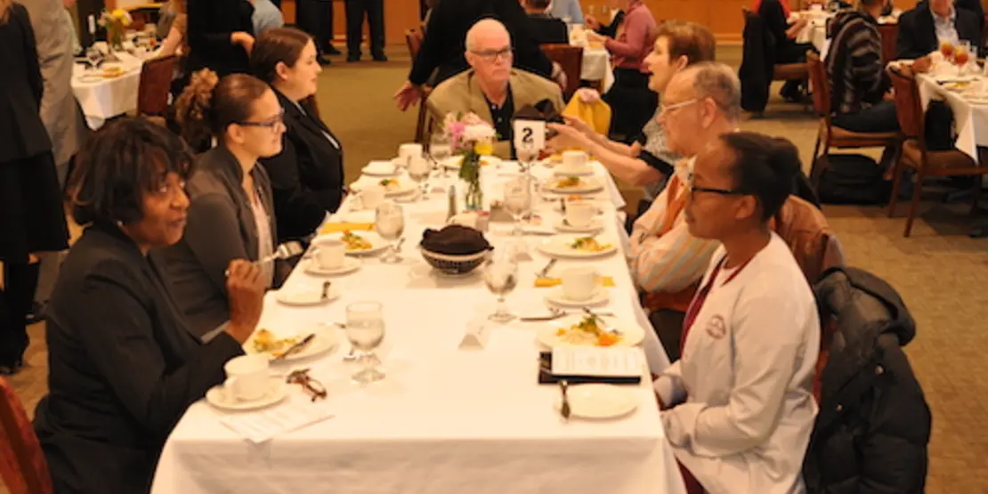 Group of scholarship students at a dinner table