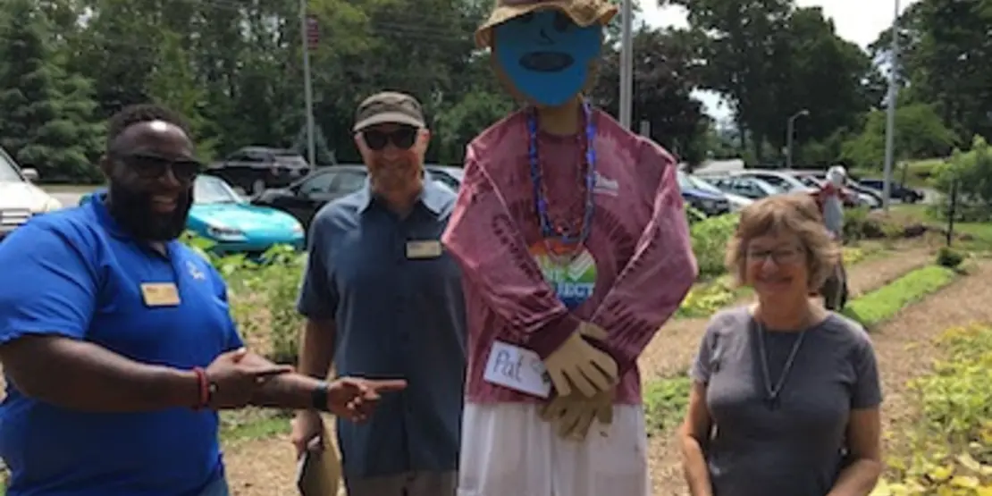 Three people and a scarecrow