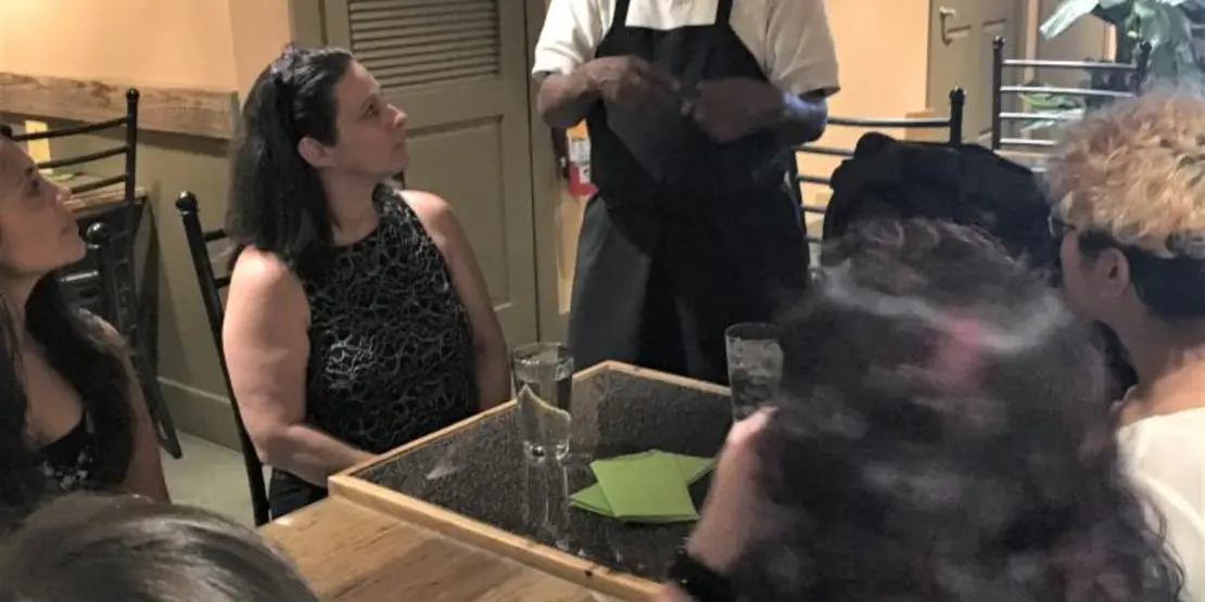 Chef talking to a group of people at a table