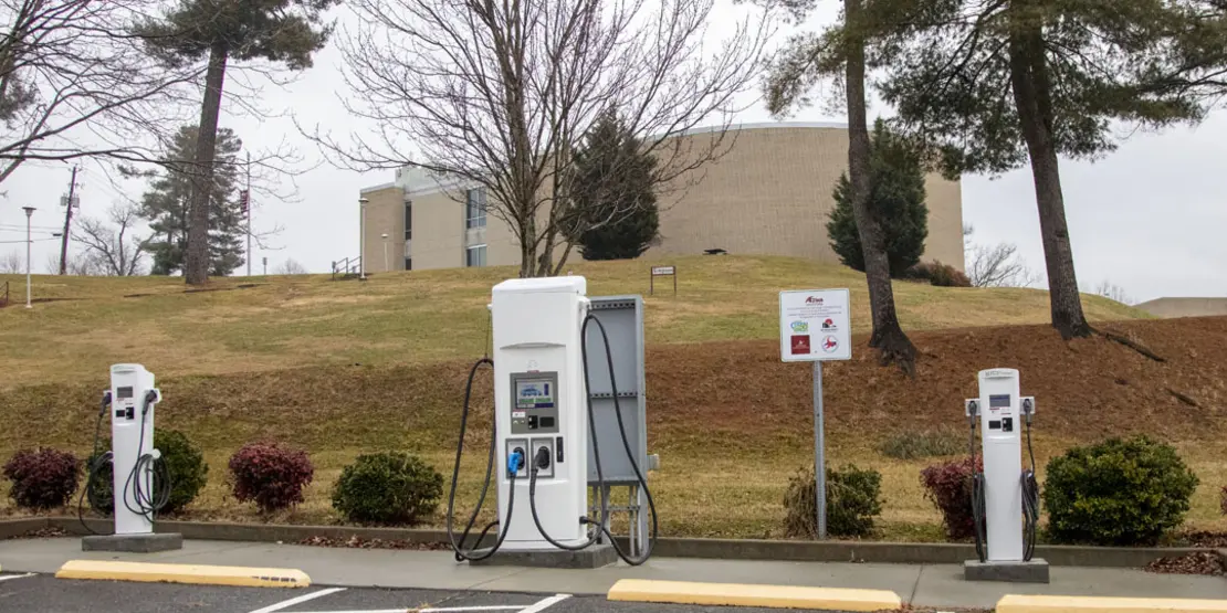 Three charging units in a parking lot