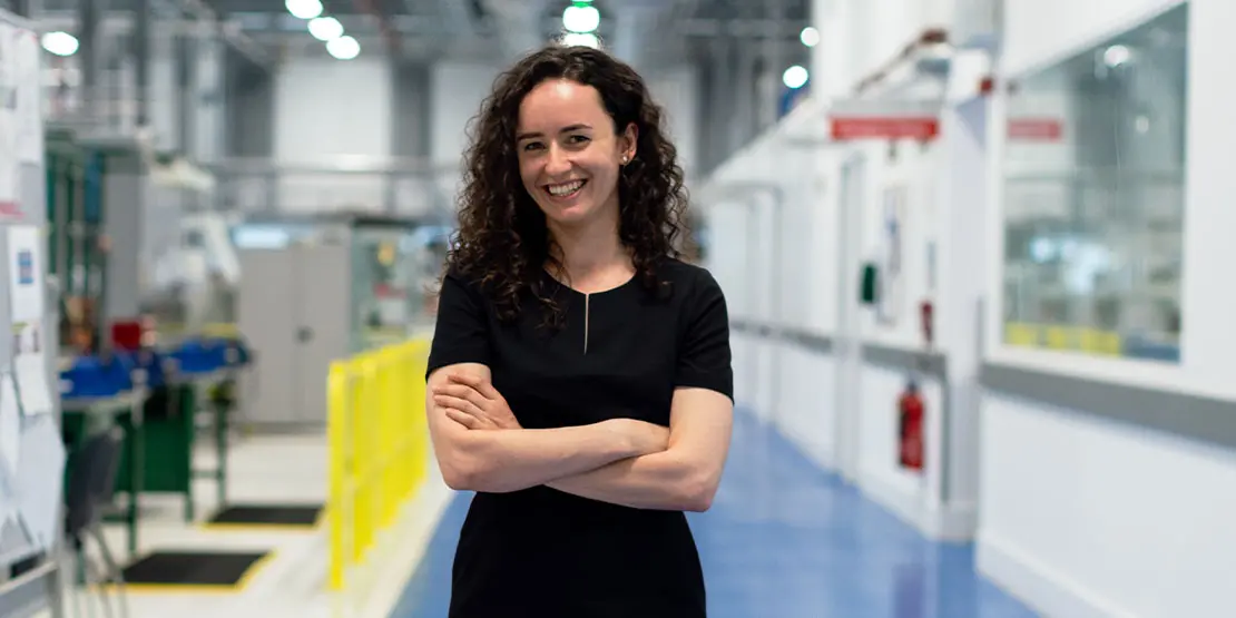 Smiling woman with arms crossed