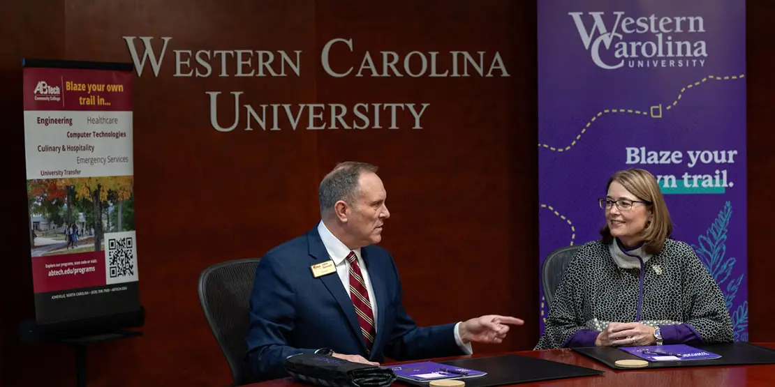 John Gossett, president of Asheville-Buncombe Technical Community College, and WCU Chancellor Kelli Brown signing an memorandum of understanding renewal between the two institutions.