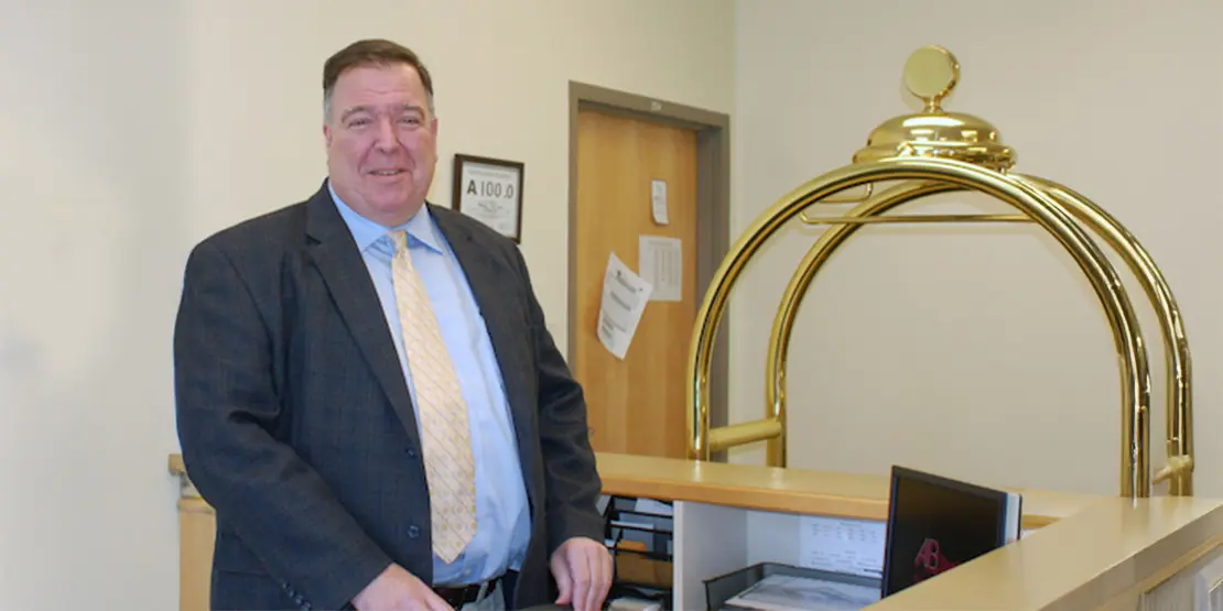 Walter Rapetski standing behind a desk