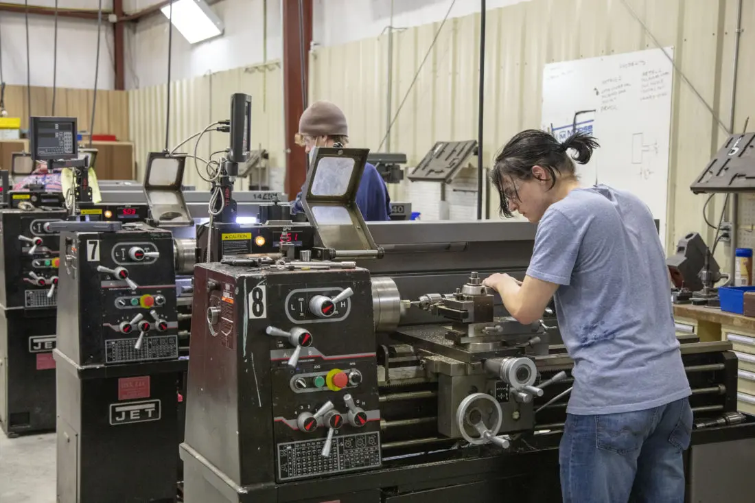 EDUCATIONAL GRIND: Madison High School dual enrollment students practice routing edges in a machining class. Photo courtesy of A-B Tech