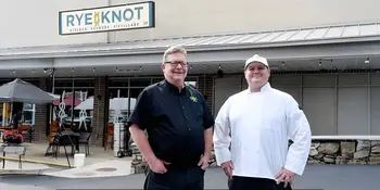 Man and chef in front of distillery