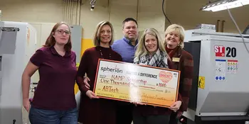 Five people with a giant check